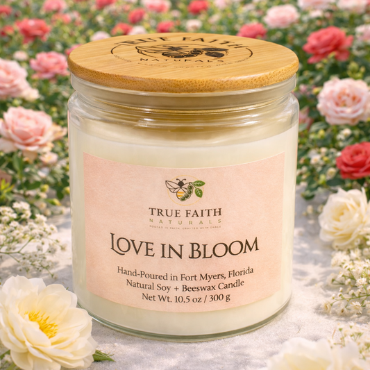 Candle jar labeled 'Love in Bloom' with a wooden lid, set against a floral background.